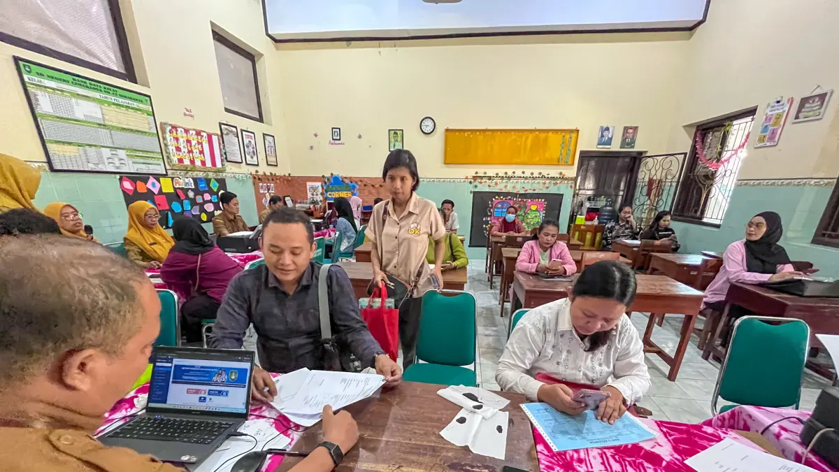 Orang tua mengantarkan anaknya mendaftar SPMB 2026 jalur domisili di SDN Cemara Dua Solo, Senin (29/6). (M IHSAN/RADAR SOLO) 