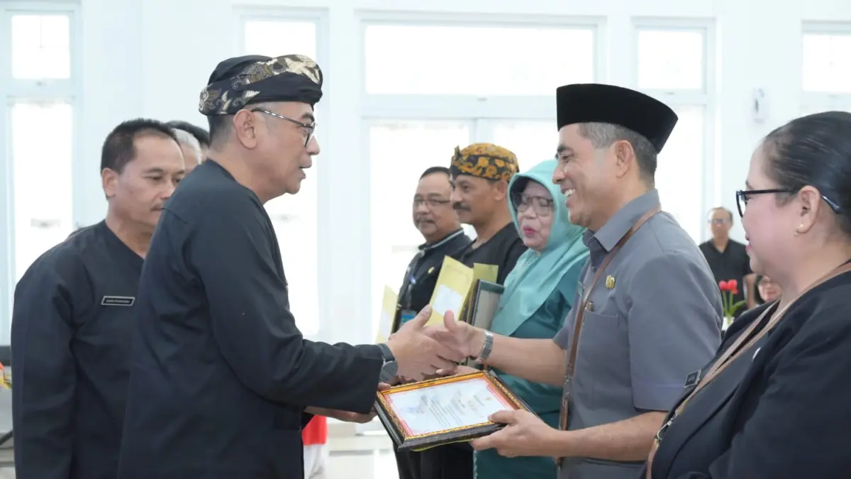 Sekda Karanganyar Kurniadi Maulato (kiri) serahkan SK kepada ASN disdikbud yang pensiun, Sabtu (1/8/2026). (Rudi Hartono/Radar Solo)