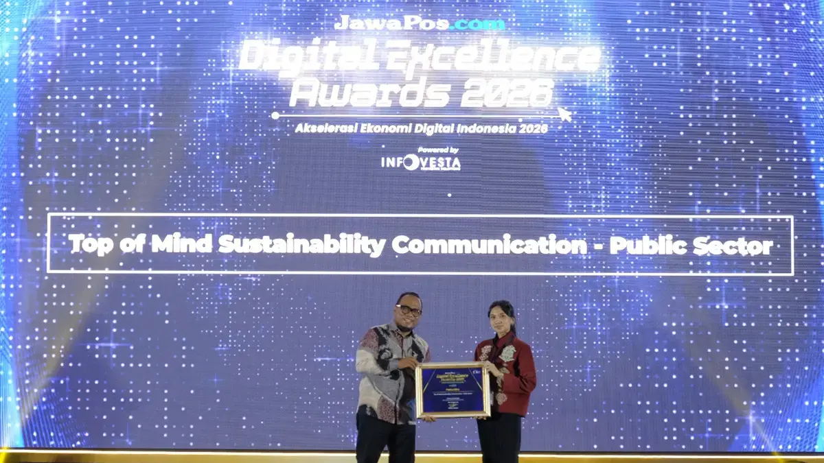 CEO JawaPos.com Dhimas Ginanjar menyerahkan penghargaan Top Sustainability Communication by Energy & Infrastructure dalam ajang Jawa Pos Digital Excellence Award 2026.  kepada Sr. Officer Media Communication PT Pertamina (Persero), Intania Prionggo di Hotel Bidakara, Jakarta Selatan, Kamis (30/7). (Istimewa)