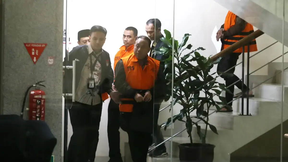 Rektor Unsoed Akhmad Sodiq dan Wakil Rektor Bidang Kemahasiswaan Norman Arie Prayogo menuju mobil tahanan usai menjalani pemeriksaan di Gedung Merah Putih KPK, Jakarta, Sabtu (22/8/2026) dini hari. (Dery Ridwansah/JawaPos.com)