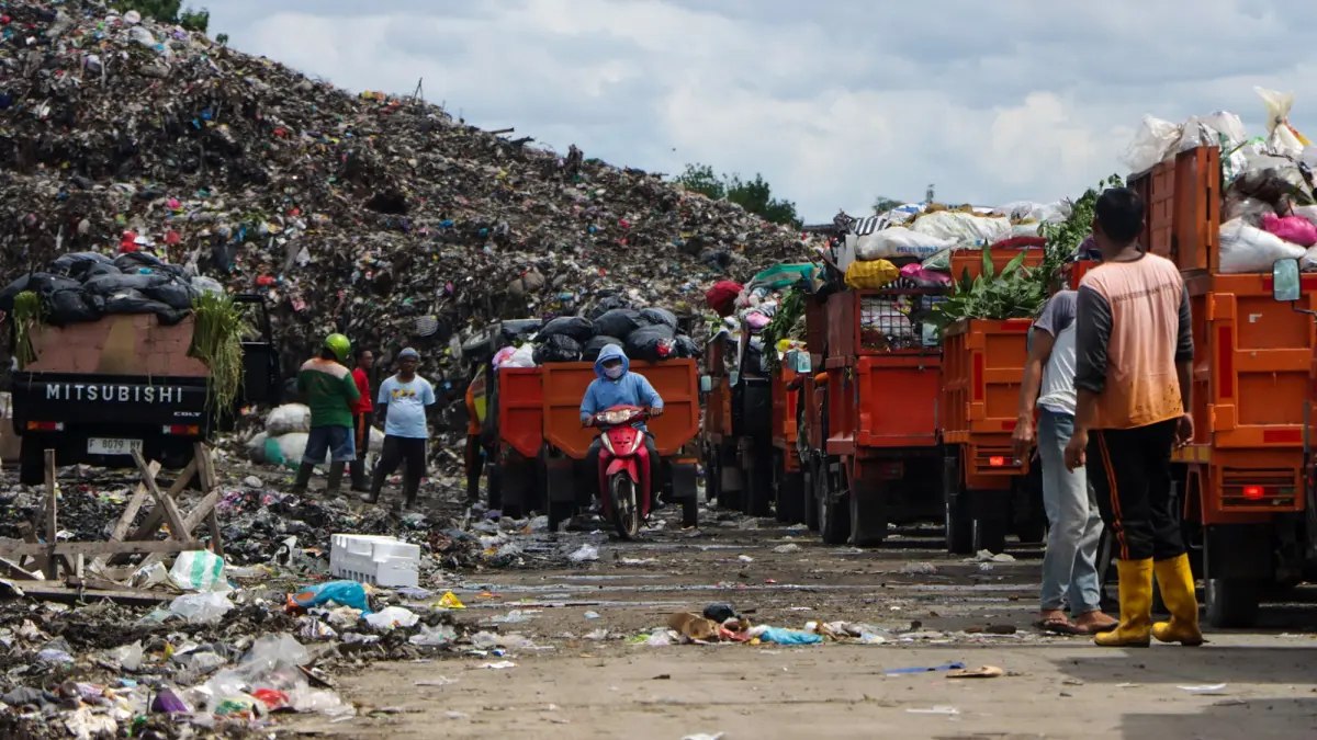 Petugas pengangkut sampah sedang bongkar muatan di TPA Putri Cempo. (M Ihsan/Radar Solo)
