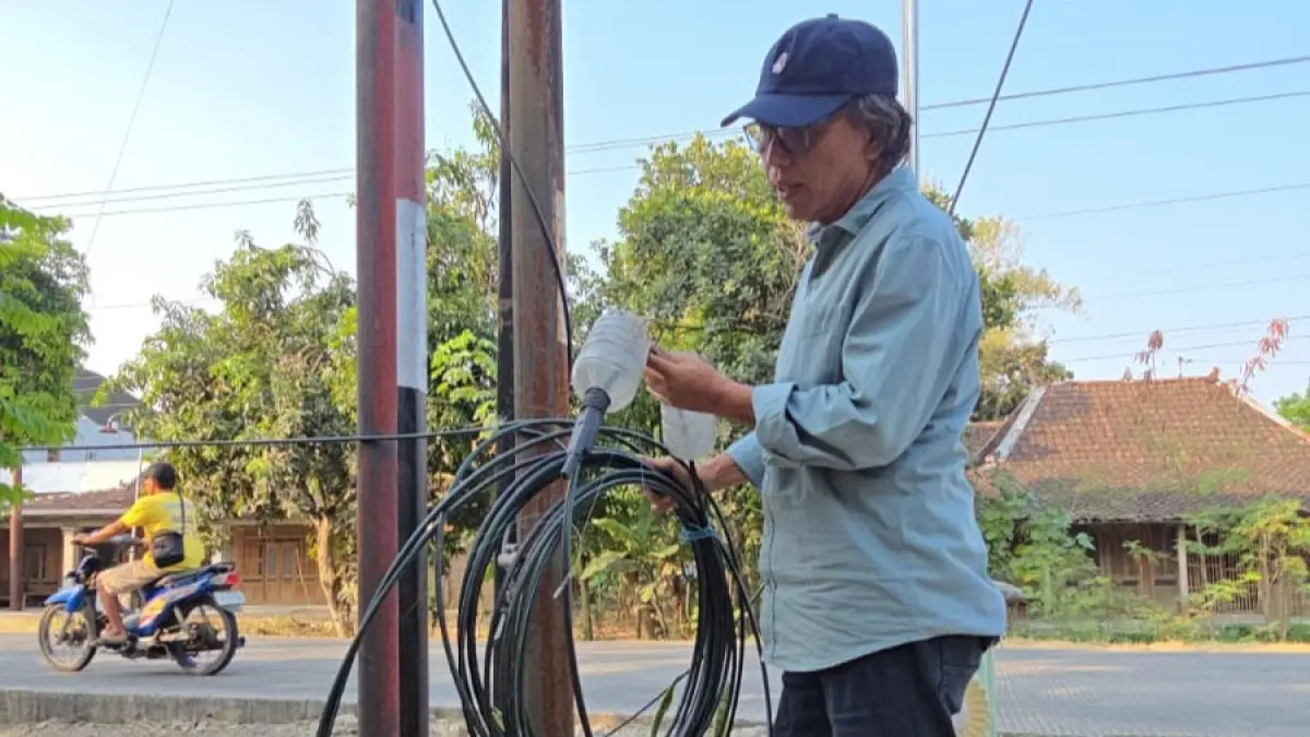 Kabel provider internet di Sragen yang semrawut hingga menyebabkan kecelakaan pengendara yang melintas. (Ahmad Khairudin/Radar Solo)