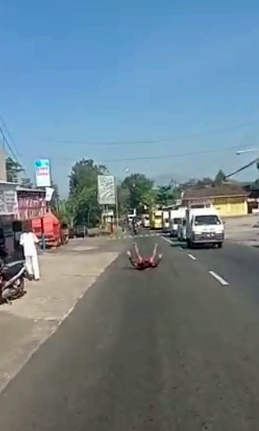 REBAHAN DITENGAH JALAN: Tangkapan layar video viral orang yang tidur di tengah jalan di Ngadirojo, Wonogiri, kemarin. (ISTIMEWA)