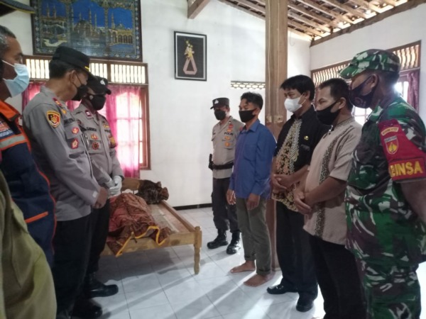 NEKAT: Polisi beserta perangkat desa menyerahkan korban gantung diri ke keluarga. (AHMAD KHAIRUDIN/RADAR SOLO)