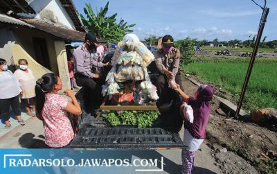 Mobil patroli Polsek Kartasura keliling di wilayahnya patroli sambil bagikan sayur ke warga, kemarin.
