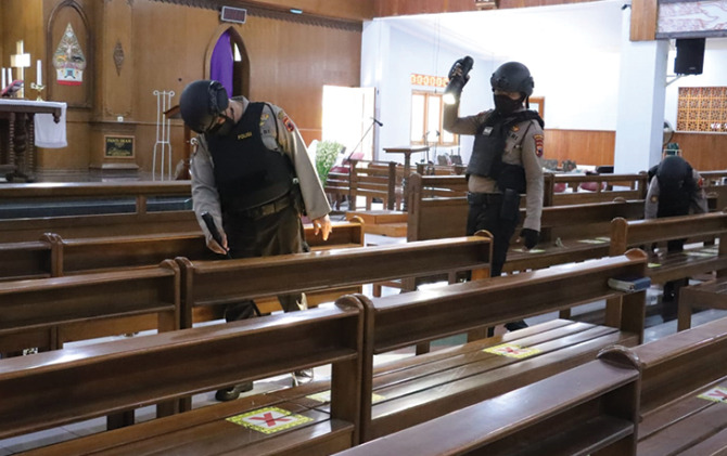 Polisi sterilisasi di Gereja Hati Kudus, Sukoharjo Kota. (IWAN KAWUL/RADAR SOLO)