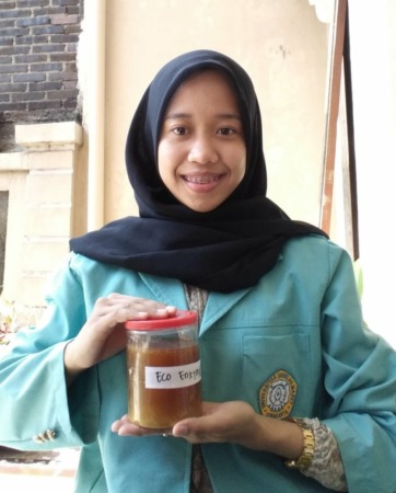 Dewi Diharjo dengan pupuk cair berbasis Eco Enzyme buatannya. (DOK. PRIBADI)