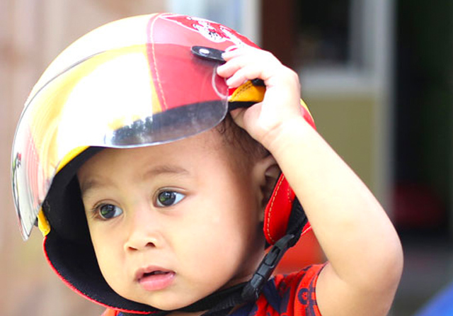 PASTIKAN ANAK AMAN: Mengajak anak balita naik mkotor perlu ekstra persiapan. Hindari menempatkan anak di depan karena justru terpapar angin dan debu lebih banyak. (Ilustrasi diperagakan model. Dite Surendra/Jawa Pos)