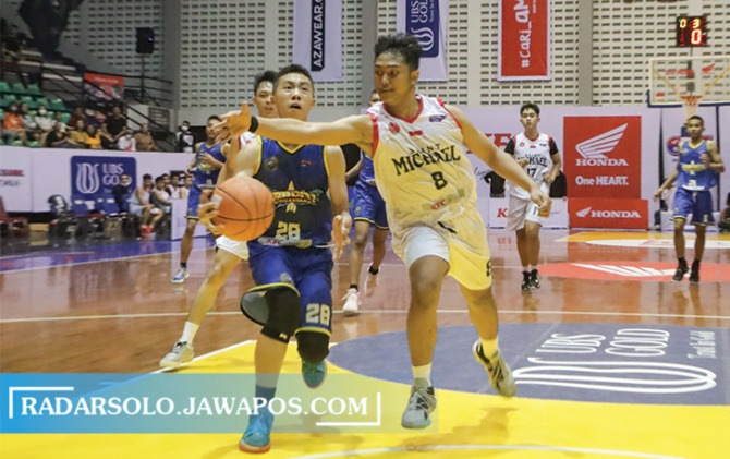 FIGHT: Pertandingan SMA Pradita Dirgantara Boyolali (jersey biru) melawan SMK St Mikael di ajang Honda DBL with KFC 2022 Central Java Series-South Region di Sritex Arena, Selasa (11/10). (M. IHSAN/RADAR SOLO)