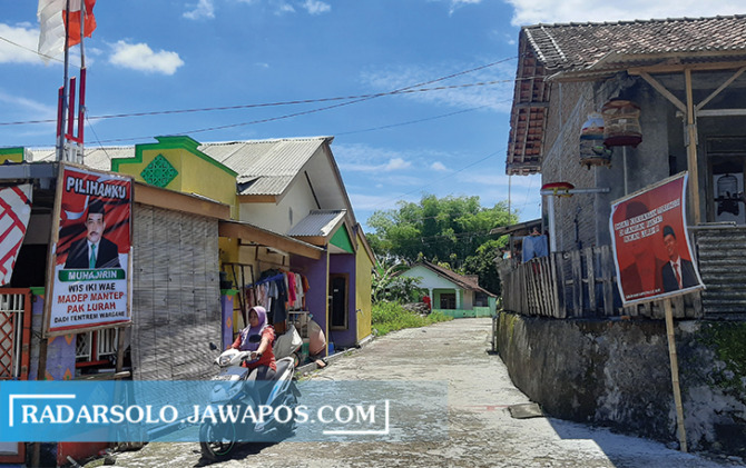TERSEBAR MERATA: Perang poster, spanduk bakal calon kepala terpasang di Desa Manggis, Mojosongo, Selasa (8/11). (RAGIL LISTYO/RADAR SOLO)