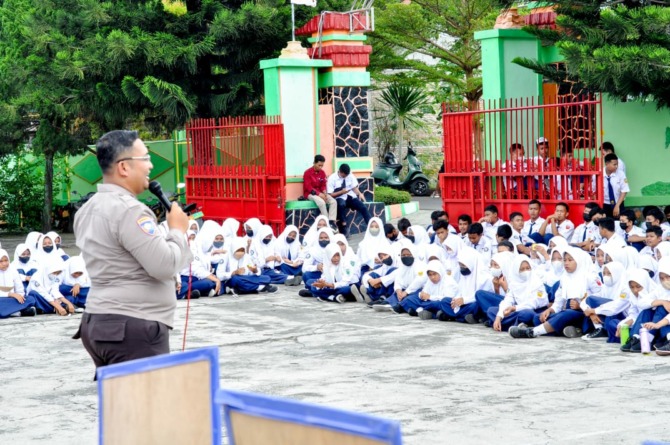 BERI IMBAUAN: Petugas Polres Klaten sosialisasi keselamatan berlalu lintas ke siswa SMP. (ANGGA PURENDA/RADAR SOLO)