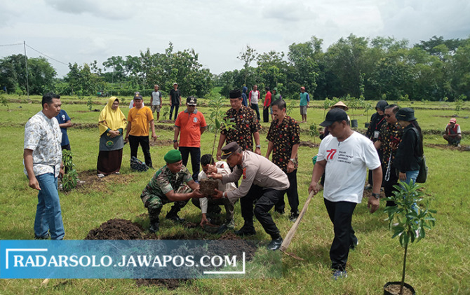 KAYA MANFAAT: Forkopimcam polokarto menanam bibit alpukat di desa setempat, Jumat (20/1/2023). (IWAN KAWUL/RADAR SOLO)