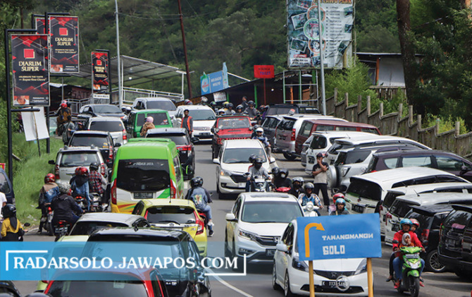 PUNCAK LIBUR: Kendaraan padat merapat di jalan menuju objek wisata Tawangmangu dan Ngargoyoso pada libur tahun baru Minggu (1/1/2023). (M. IHSAN/RADAR SOLO)