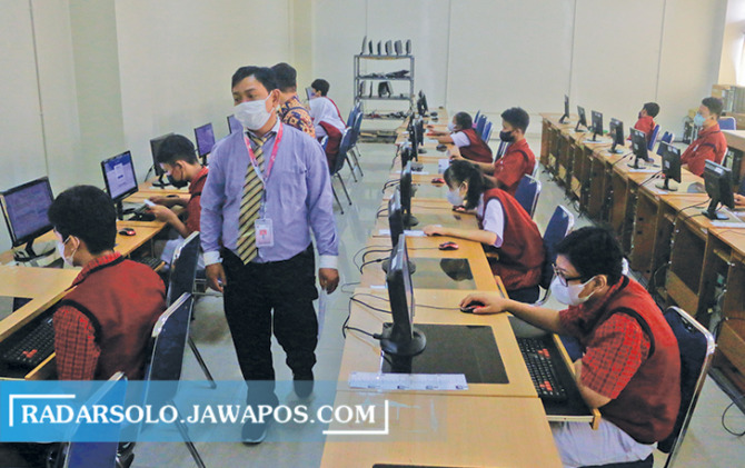 DIMAKSIMALKAN: Guru mendampingi siswanya melaksanakan asesmen nasional berbasis komputer di SMP swasta, belum lama ini.