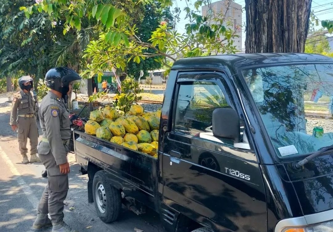 DITERTIBKAN: Petugas Satpol PP menertibkan pedagang yang berjualan di bahu jalan. (IST)