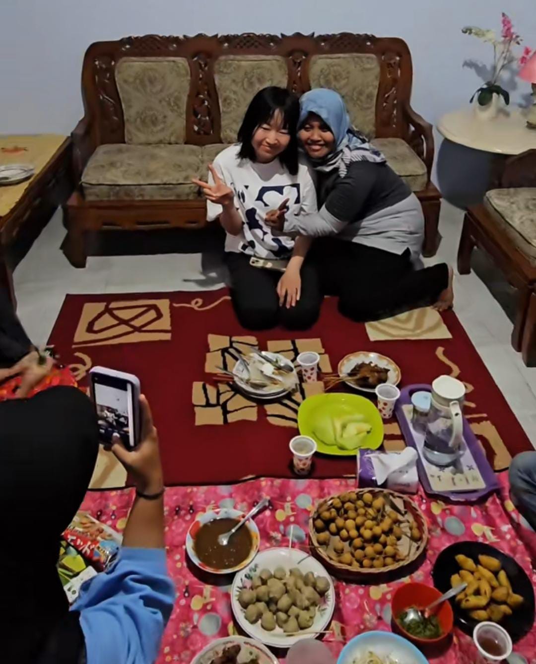 FANS DADAKAN: Tetangga Faris bergantian berfoto dengan kekasihnya, Miku. (IST/akun TikTok @fariscinemart)
