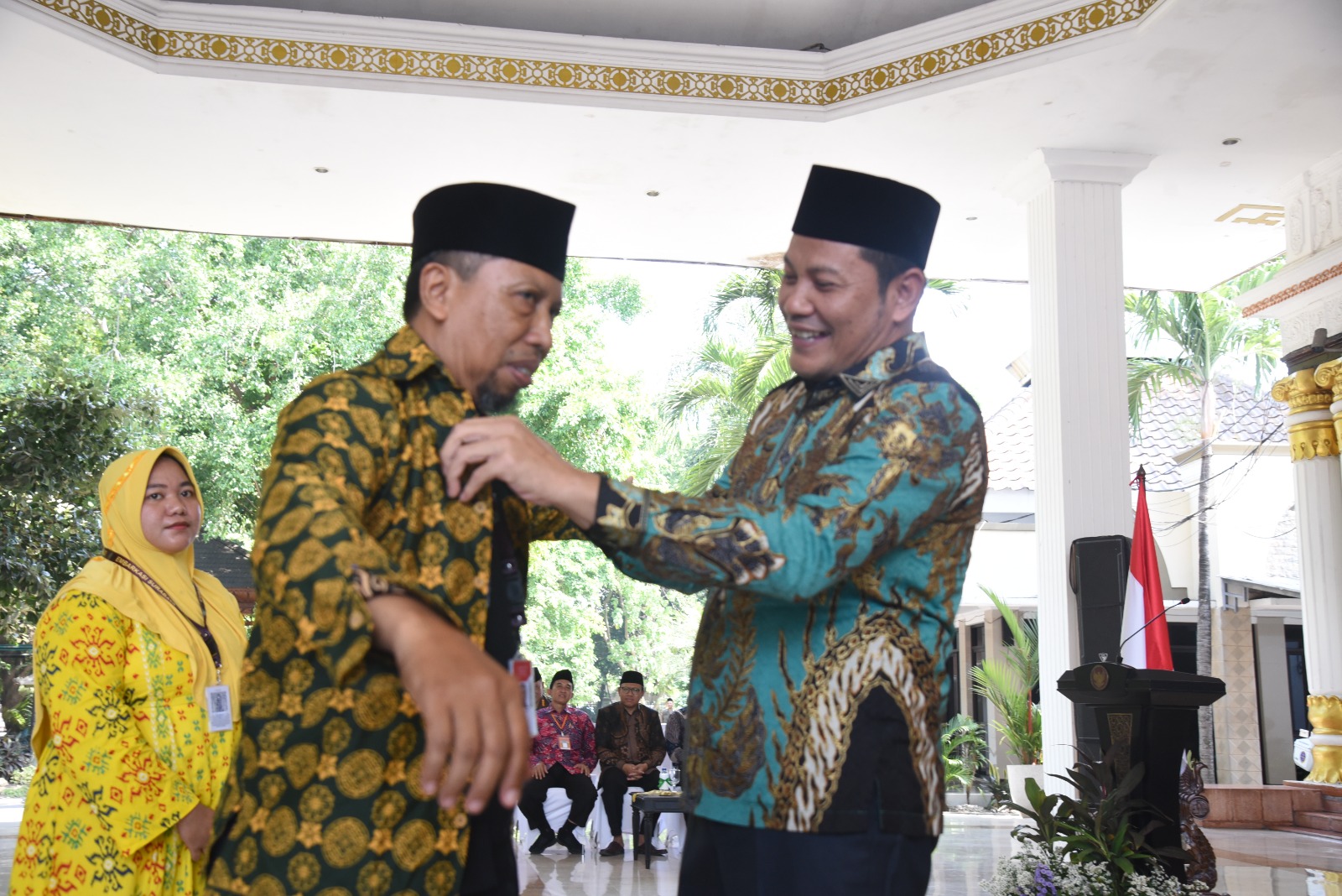 IBADAH: Plt Bupati Sidoarjo Subandi memakaikan baju batik kepada Calon Jamaah Haji asal (CJH) Sidoarjo. (M SAIFUL ROHMAN/RADAR SIDOARJO)