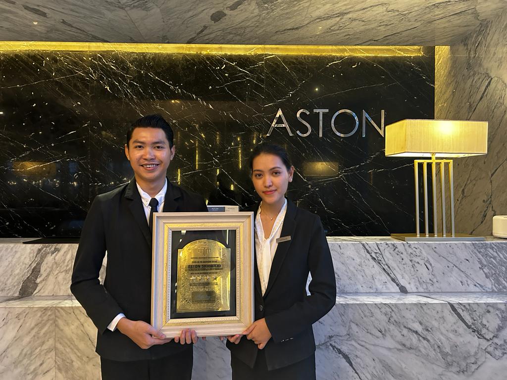 BANGGA: Resepsionis ASTON Sidoarjo membawa plakat Hotel Bintang 4. (IST)