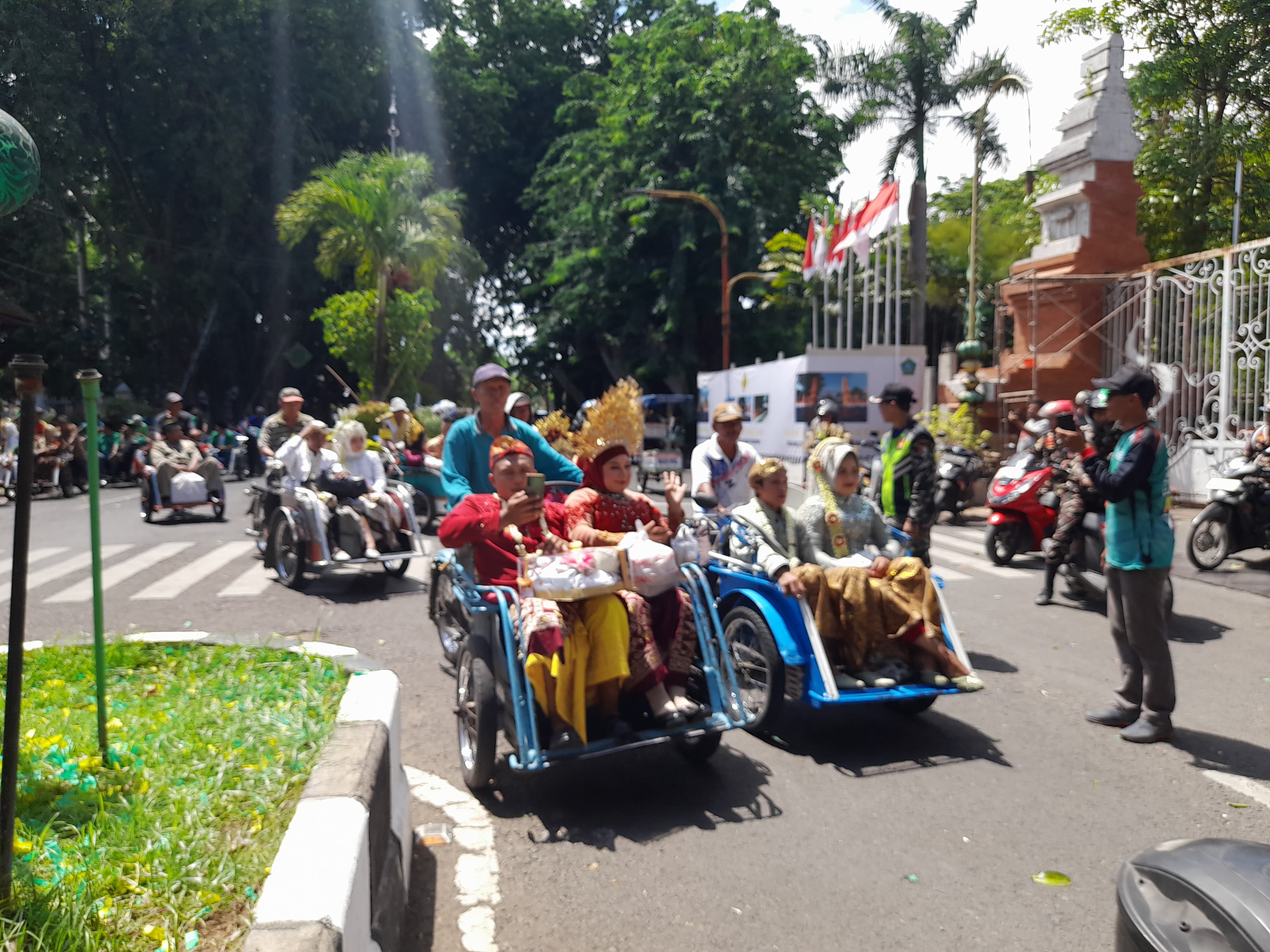 BAHAGIA: Pasangan calon nikah massal saat diberangkatkan ke hotel menggunakan becak motor. (M SAIFUL ROHMAN/RADAR SIDOARJO)