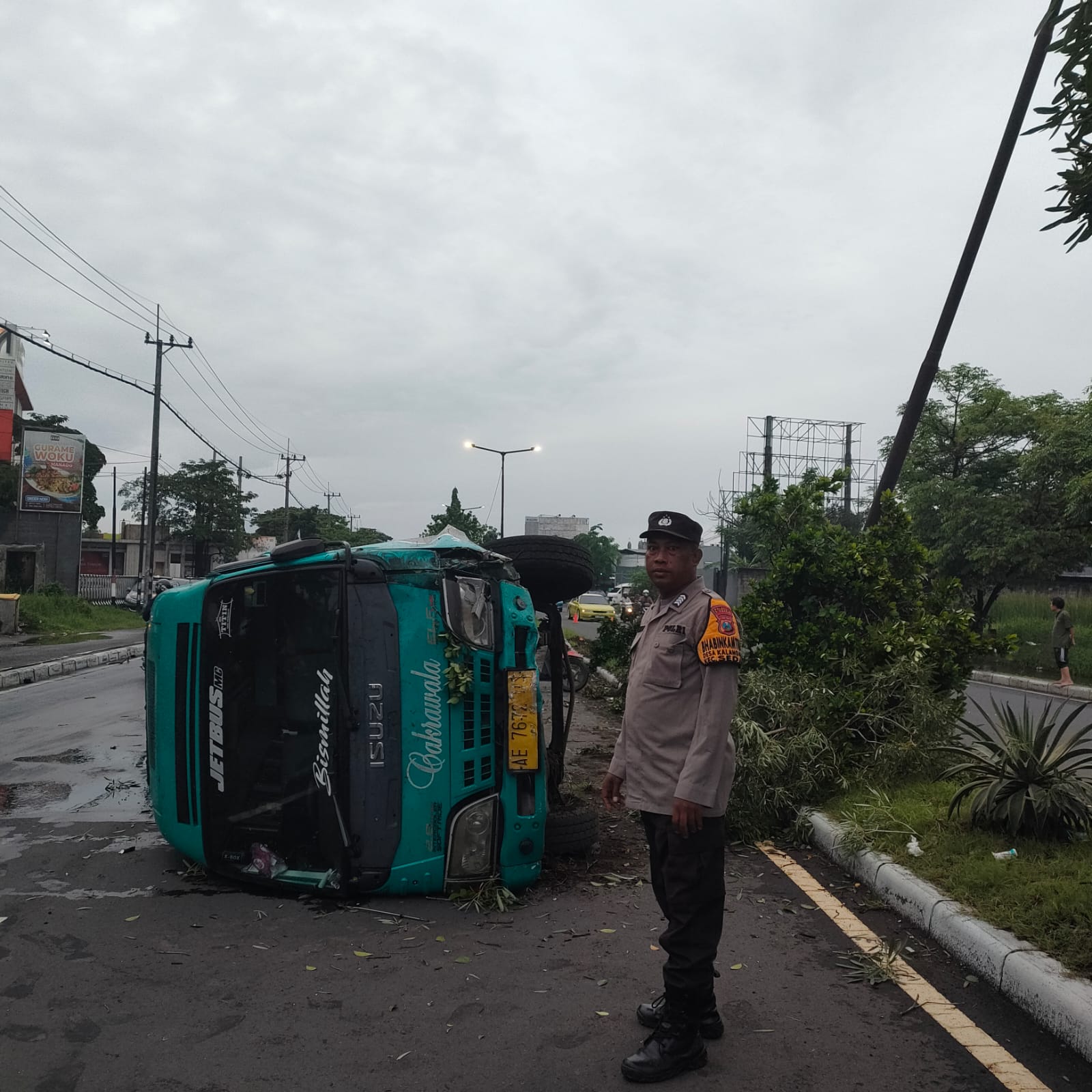 RINGSEK : Kondisi mobil elf yang terguling di Jalan Bypass Juanda, Sedati, Sidoarjo, Selasa (21/1). (IST/RADAR SIDOARJO)