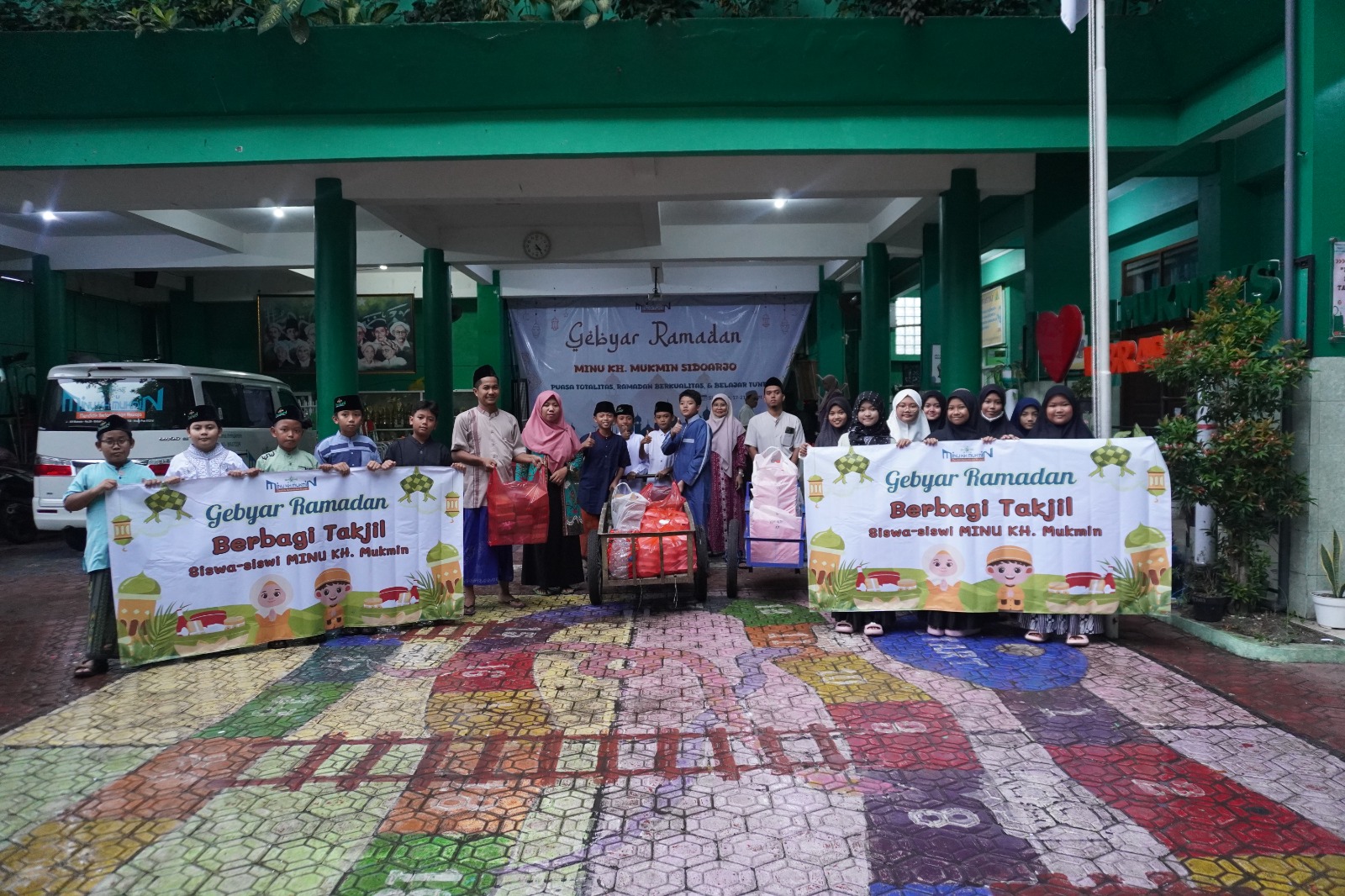 BERBAGI : Kepala MINU KH Mukmin sidoarjo Hj Anis Faridah bersama siswa sebelum melakukan kegiatan bagi takjil. (ANAS/RADAR SIDOARJO)
