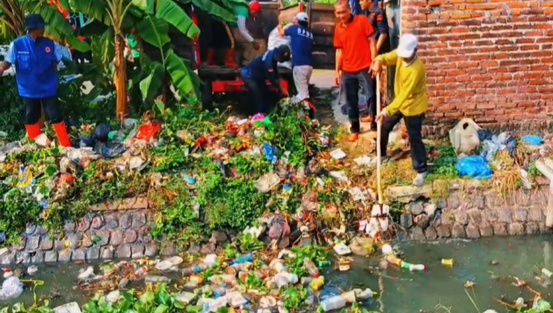 GOTONG ROYONG: Warga kompak membersihkan sampah yang menumpuk di aliran sungai Gedangrowo, Desa Kalidawir, Tanggulangin, Sidoarjo. (IST/RADAR SIDOARJO)