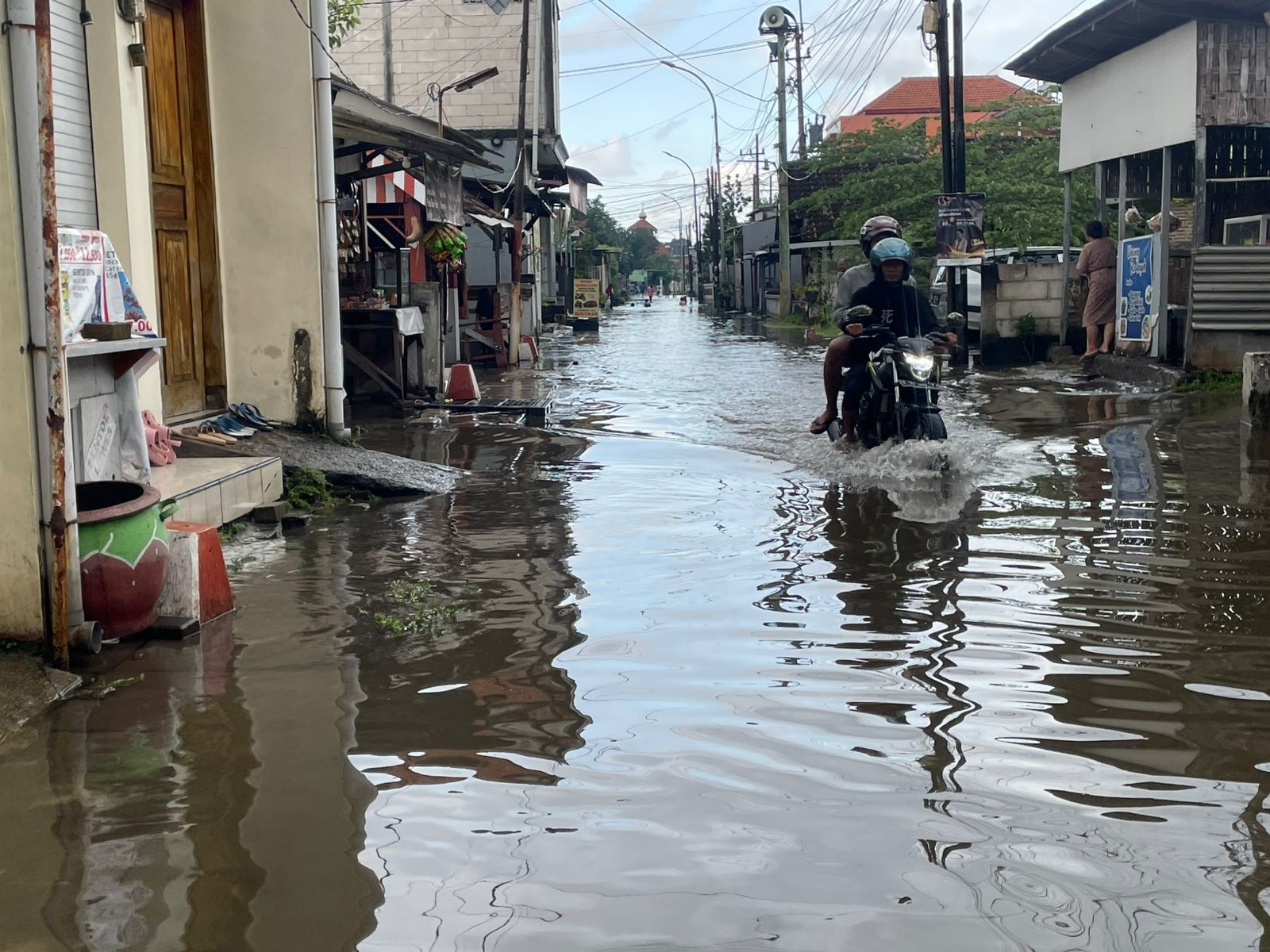 LANGGANAN: Pengendara motor saat melintasi banjir yang menggenangi kawasan Bringinbendo, Taman, Senin (12/5). (DIKY PUTRA SANSIRI/RADAR SIDOARJO)