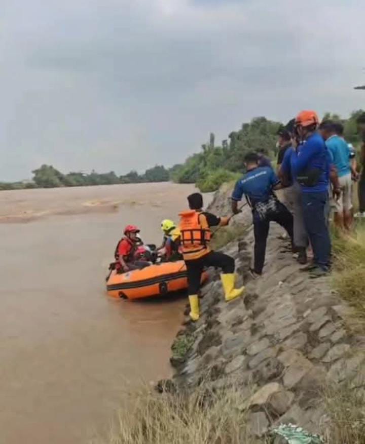 EVAKUASI: Relawan sedang mengangkat jenazah korban dari sungai.  &nbsp;