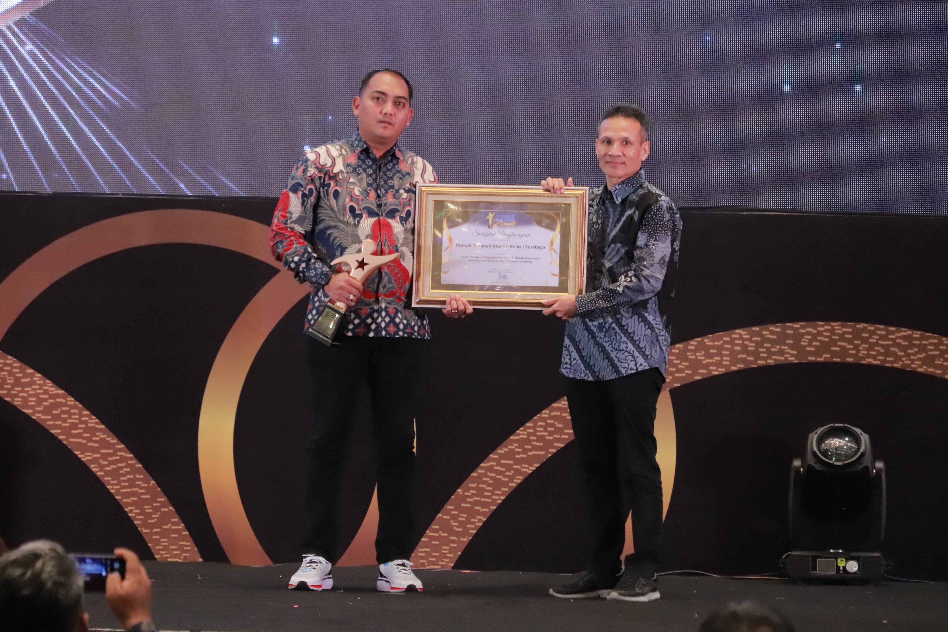 APRESIASI: Kepala Kesatuan Pengamanan Rutan (Ka KPR) Hengki Giantoro (kiri) yang hadir mewakili Kepala Rutan (Karutan) Kelas I Surabaya, Tomi Elyus menerima penghargaan Radar Surabaya Award.