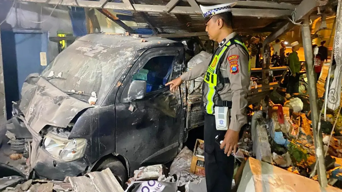 NAHAS: Mobil Gran Max menabrak bangunan usai menerjang pemotor di Balongbendo.