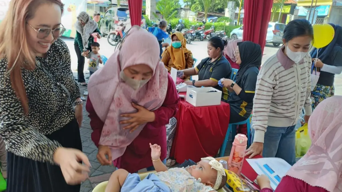 GRATIS: Warga Bougenville Perumahan Grand Royal Regency Sidoarjo ini merasa senang ketika posyandu yang biasanya digelar di Balai RT sekarang pindah di depan halaman Alfamart Grand Royal Regency, Rabu (8/7/2026).