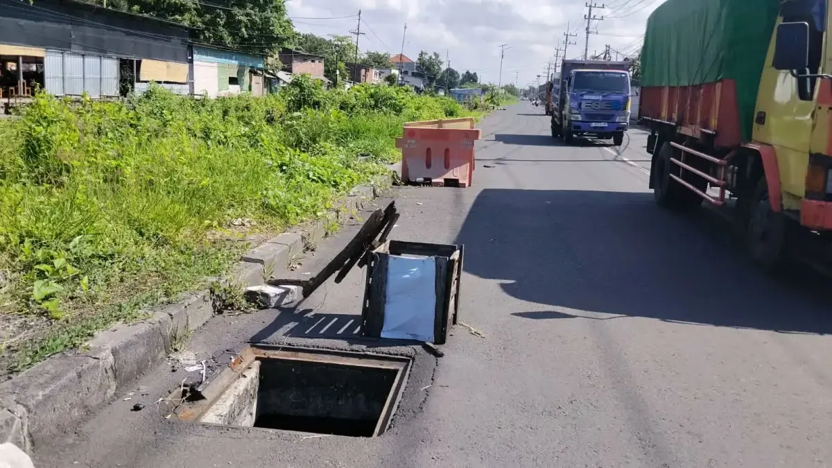 MEMBAHAYAKAN: Penutup got di ruas Frontage Road Gedangan hilang. (DIKY SANSIRI/RADAR SIDOARJO)