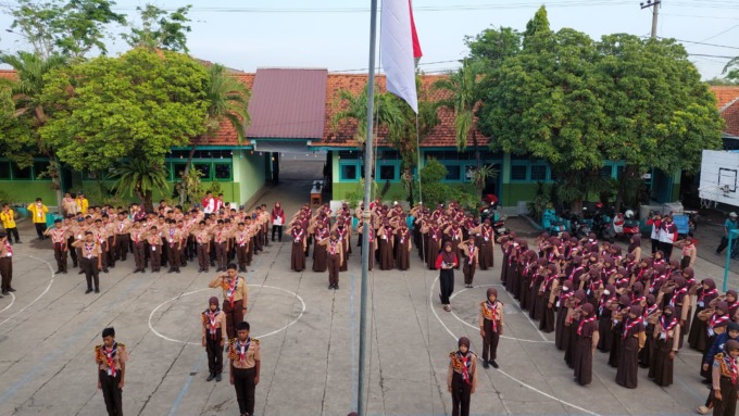 DISIPLIN: Pelaksanaan upacara saat kegiatan kemah rutin SMP Budi Utomo Prambon.