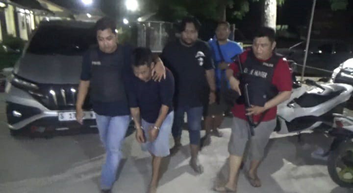 Petugas dari Polsek Mojoagung saat menggelandang Arisanto ke Mapolsek untuk diperiksa