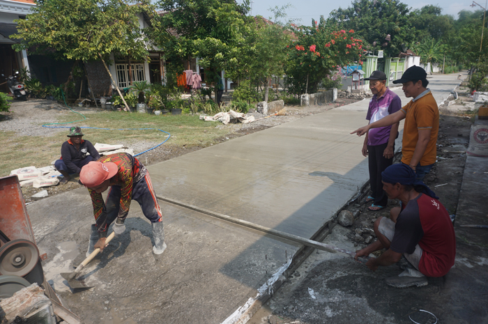 UNTUK WARGA: Kepala Desa Sentul Misbahul Arifin menunjukkan pembangun jalan rabat beton baru di desanya.