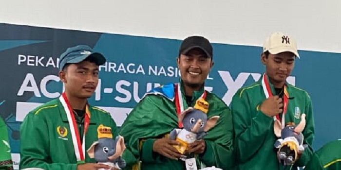 Aris (topi hitam) atlet petanque dari Jombang ketika menerima medali di PON XXI  Aceh Sumut 2024