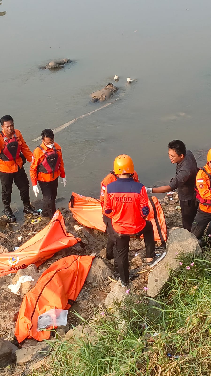 Proses evakuasi jasad 7 pemuda yang mengapung di Kali Bekasi yang diduga merupakan pelaku tawuran yang lari saat dikejar polisi