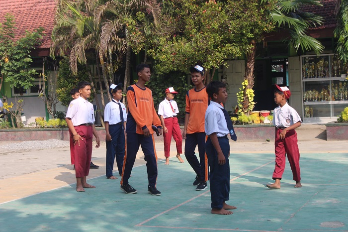 SERAGAM LAMA: Siswa kelas 7 SMPN 2 Megaluh beraktifitas di halaman sekolah menggunakan seragam lama. 