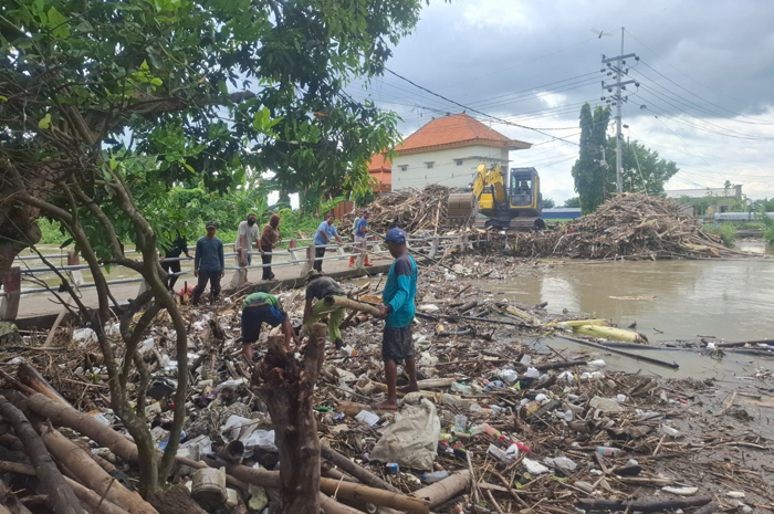DIBERSIHKAN: Alat berat amfibi membersihkan sumbatan Kali Marmoyo di Kecamatan Kabuh, (15/1).