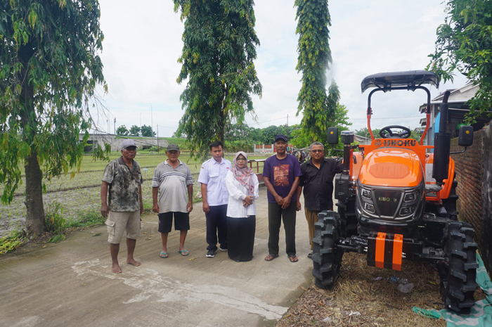 Kepala Desa Tampingmojo Nurus Sa&rsquo;adah bersama Gapoktan Tampingmojo menunjukkan bantuan alsintan traktor roda 4.