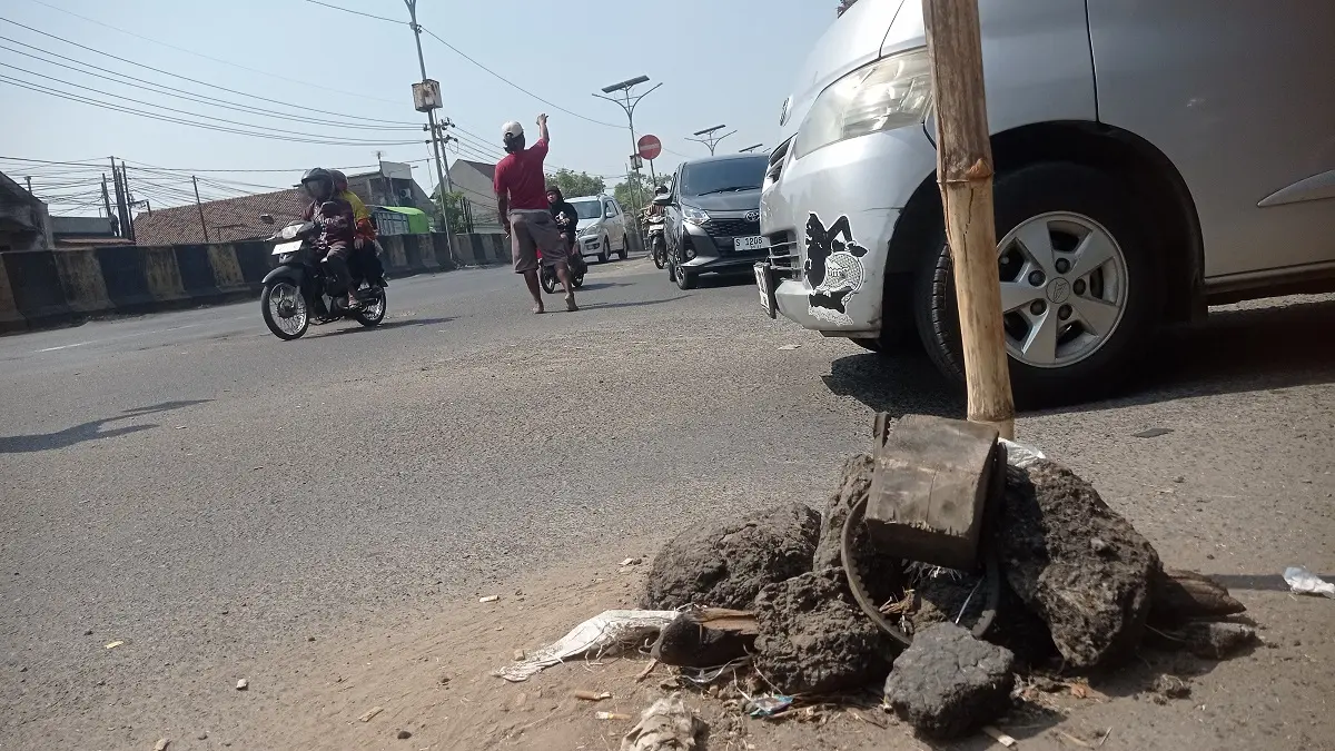 Kondisi jalan nasional di Peterongan Jombang yang bolong dan ditandai bambu