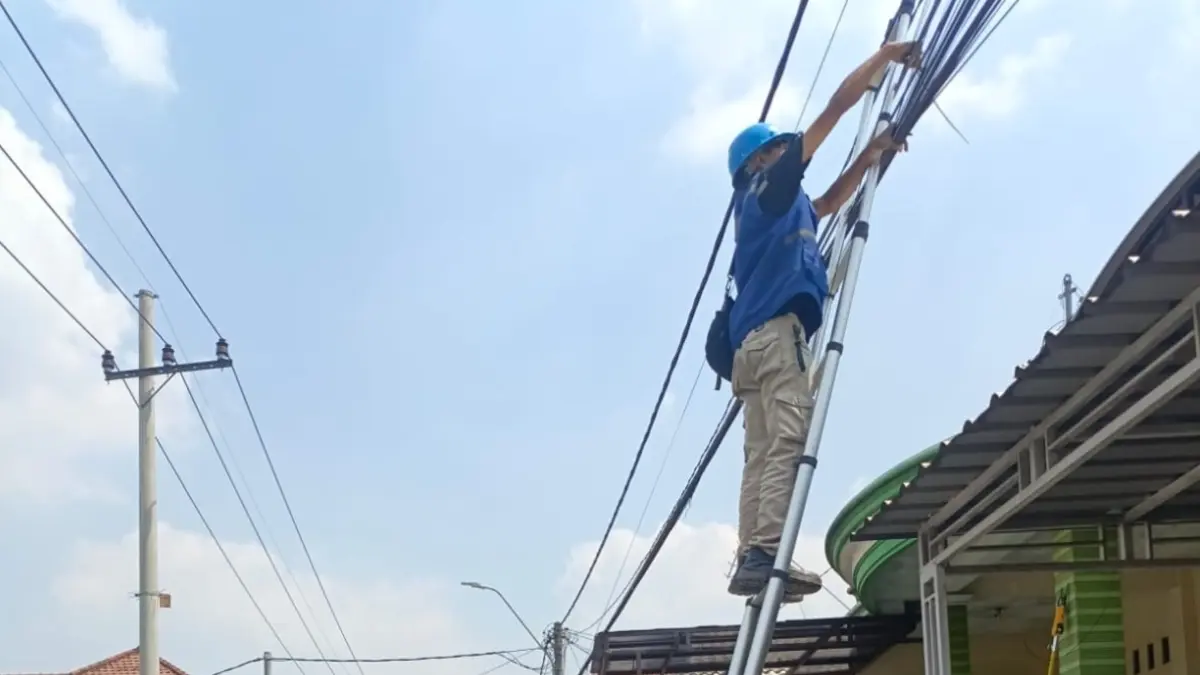 DIRAPIKAN: Petugas merapikan kabel semrawut di area PP Bahrul Ulum Tambakberas, Desa Tambakrejo, Kecamatan Jombang.