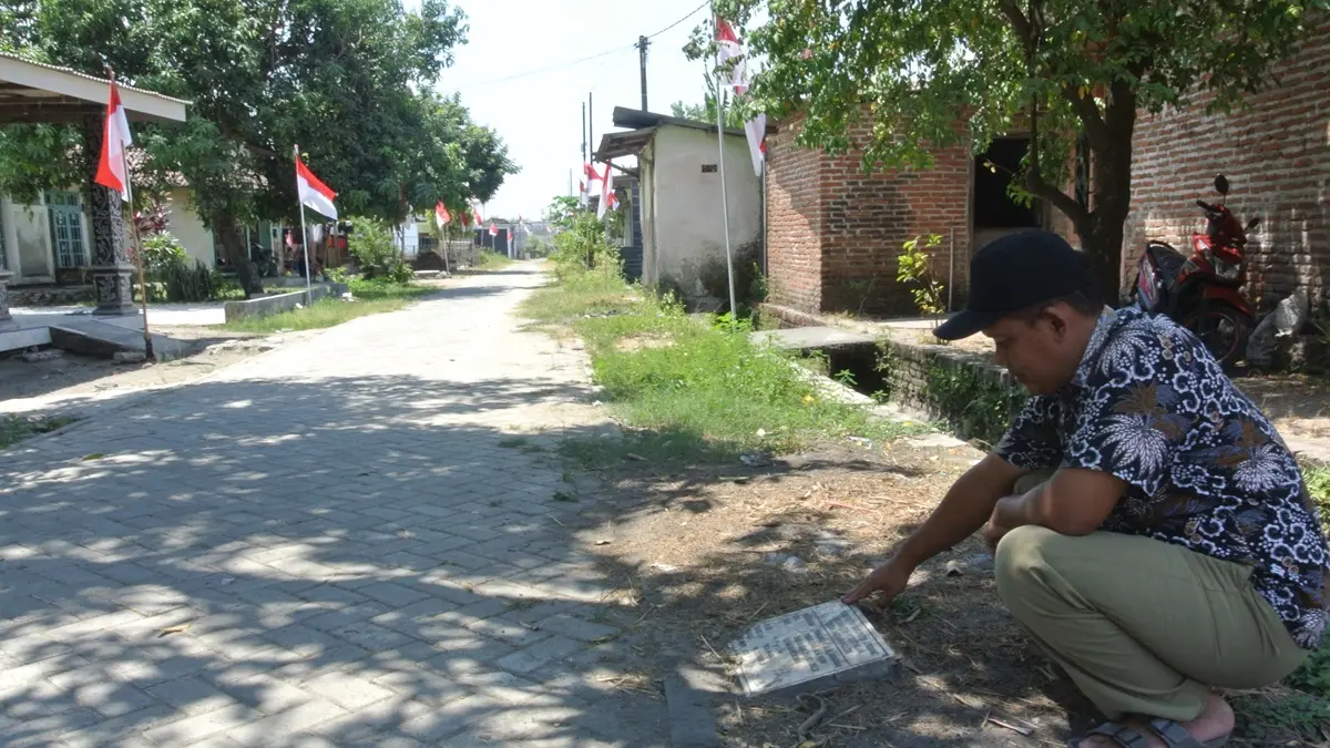 TUNJANG MOBILITAS WARGA: Kaur Perencanaan Desa Ngrandulor Lukman Ali menunjukkan lokasi pembangunan jalan paving di Dusun Ngumpak, Desa Ngrandulor.