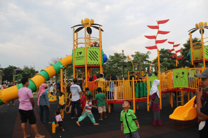 Sejumlah orang tua mengawasi anaknya yang bermain di Alun alun Jombang.