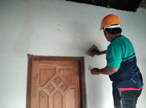 Proses perbaikan rumah milik warga yang terdampak proyek tanggul brantas.