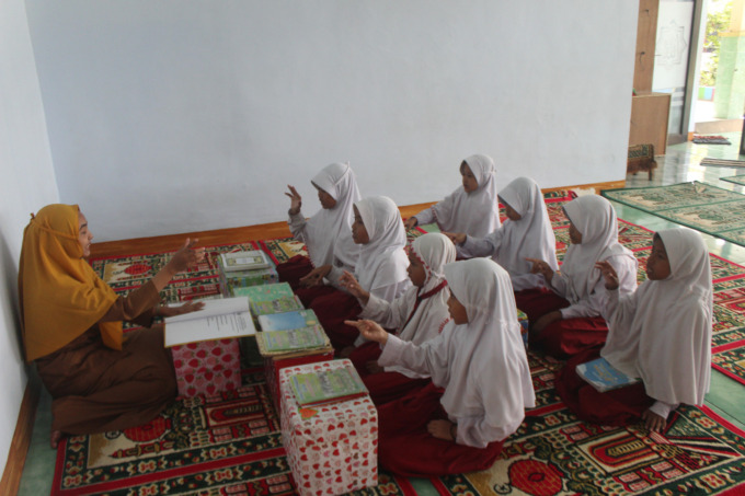 Pembimbing muatan lokal Pendidikan Diniyah SDN Kayangan 1 saat mengajar program tahfidz, Senin (27/3)