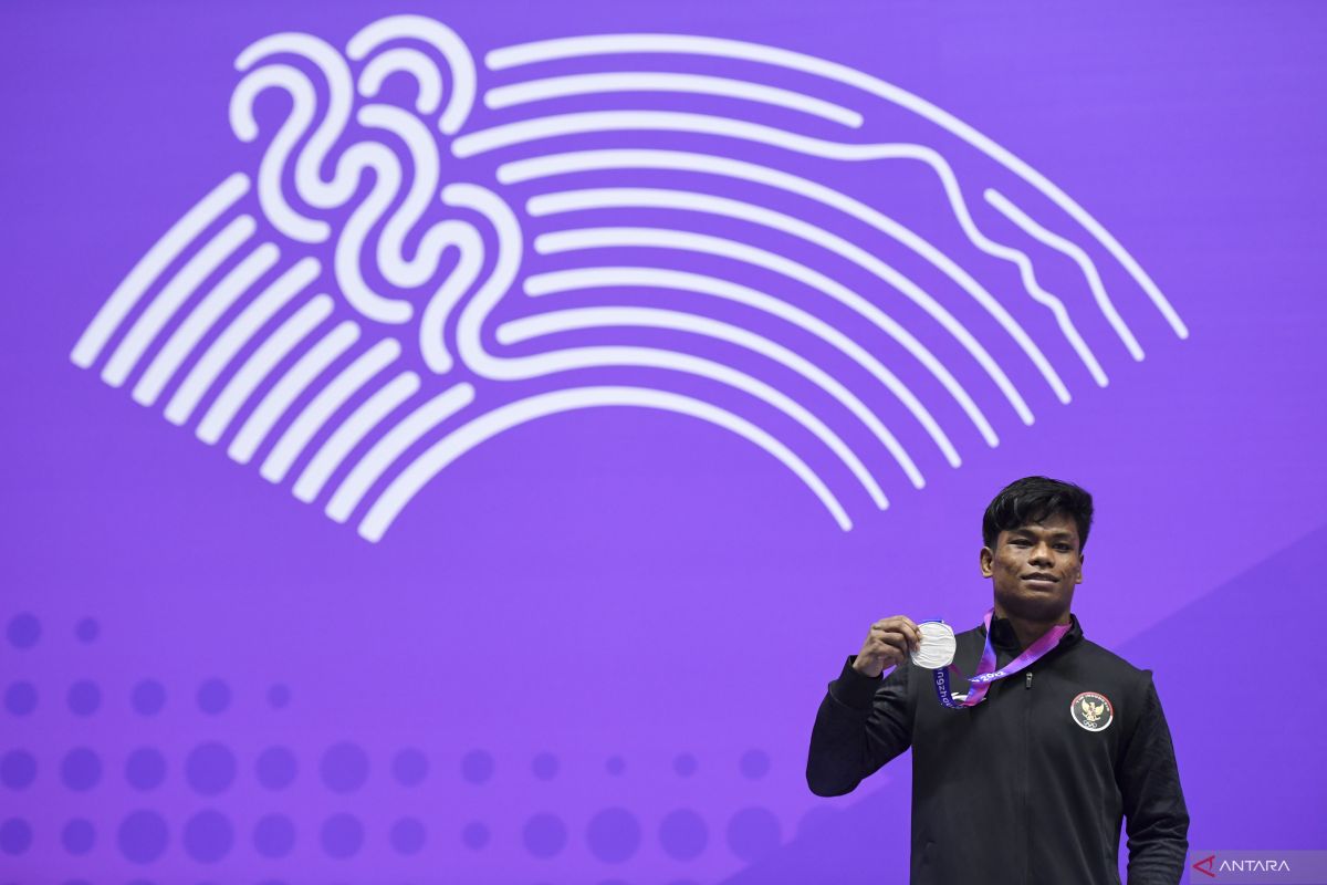Pewushu Indonesia Samuel Marbun menunjukan medali di Asian Games 2022 di Xiaoshan Guali Sports Centre, Hangzhou, China, Kamis (28/9/2023). (ANTARA)