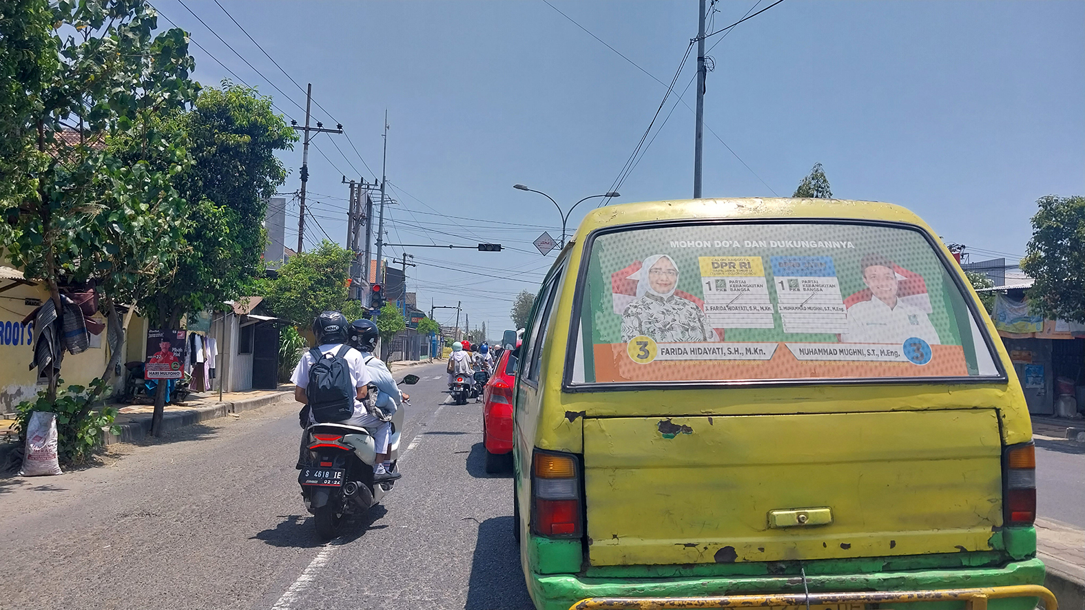 MOBIL BRANDING: Kendaraan angkutan umum yang ditempeli stiker salah satu caleg DPR RI melintas di Tuban.