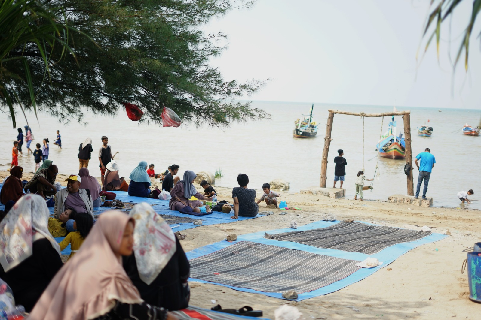 MENIKMATI LIBURAN: Membeludaknya masyarakat yang sedang berwisata di Pantai Kelapa Tuban, Selasa (26/12).