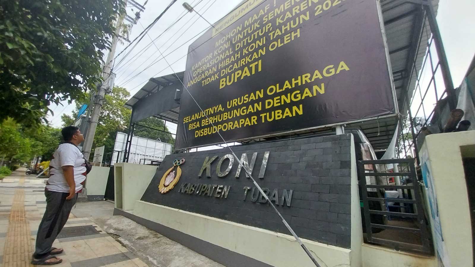 AKIBAT DANA HIBAH TAK CAIR: Banner pengumuman penutupan kantor KONI Tuban dipasang di depan kantor KONI, Senin (1/1).